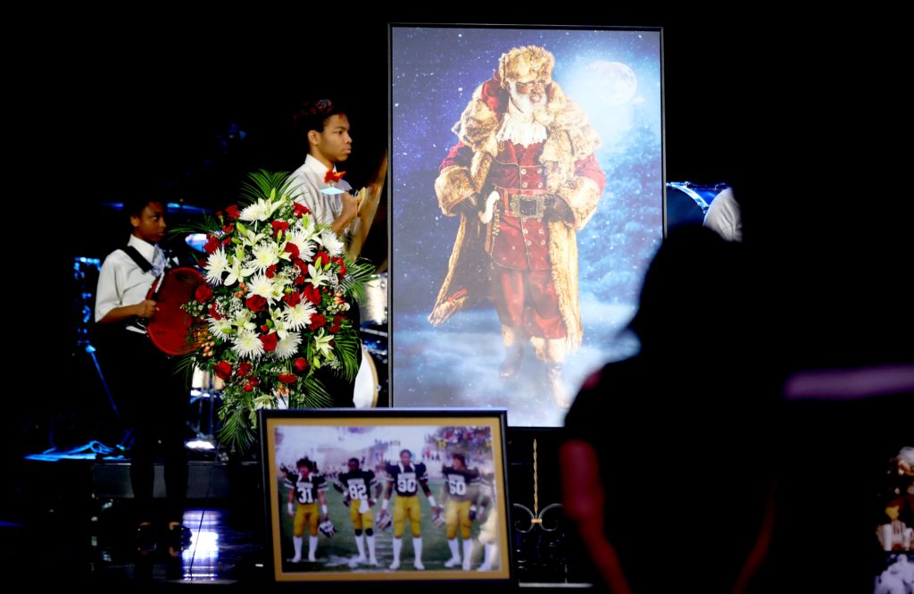 People attend a remembrance ceremony for Dr. Kenneth Wayne Blair, Sr., known as Santa Blair, at Life Church in Edmond, Okla.