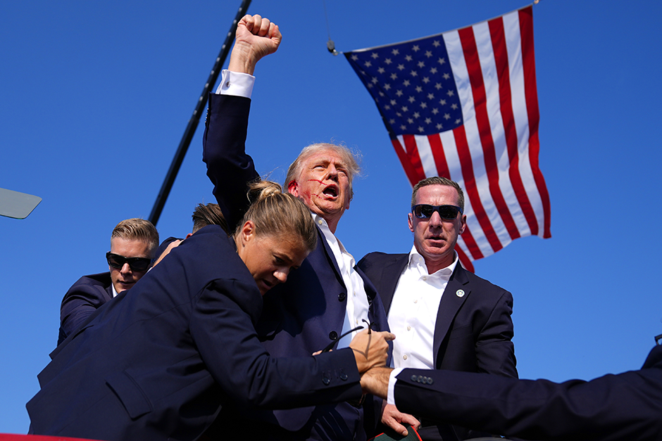 Republican presidential candidate former President Donald Trump is surrounded by U.S. Secret Service agents at a campaign rally, Saturday, July 13, 2024, in Butler, Pennsylvania.