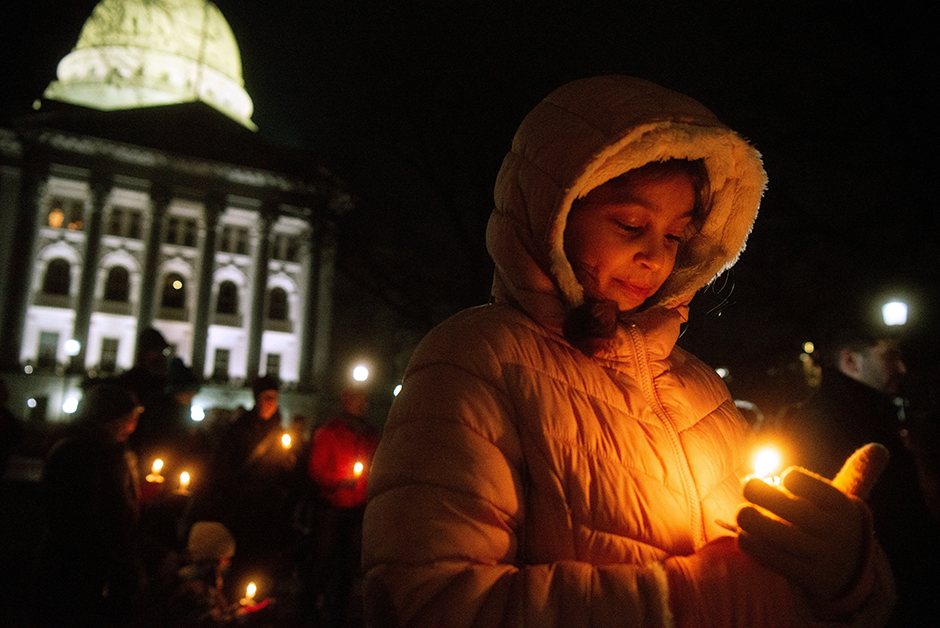 Mourners gathered for a candlelight vigil at the Wisconsin State Capitol building a day after a shooting at Abundant Life Christian School, in Madison, Wisconsin, on December 17, 2024.