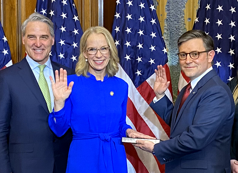 Kelly Morrison, second from left, shown during the ceremonial swearing-in on Friday. Speak Mike Johnson is at right and Morrison’s husband, John Willoughby, is at left.